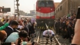 Egyptian wrestler Ashraf Mahrous, better known as Kabonga, pulls a train for nearly 10 meters, 33 feets, at Ramses Station in Cairo, Egypt, as he is watched by Guinness World Record observers, March 13, 2025. 