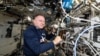 NASA astronaut Butch Wilmore shows research hardware for a study that explores 3D printing of on-demand medical devices on the International Space Station on Dec. 2, 2024.